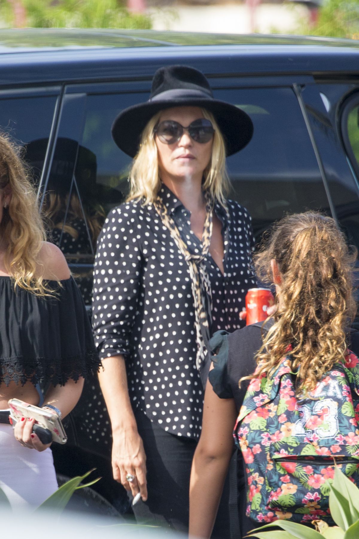 Kate Moss Drinks Beer & Smoking Waiting for Her Driver at Airport in Ibiza