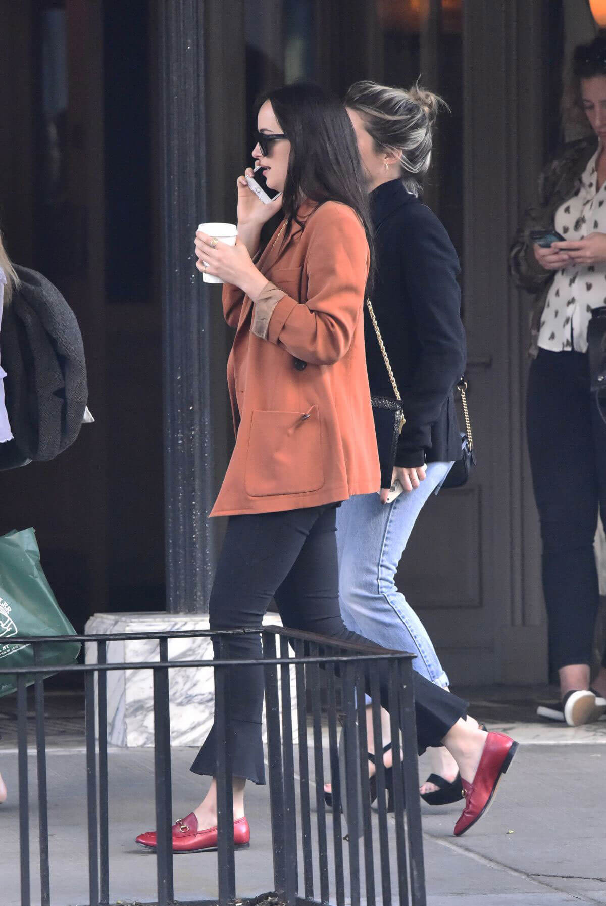 Dakota Johnson wears rust colored jacket out and about in New York