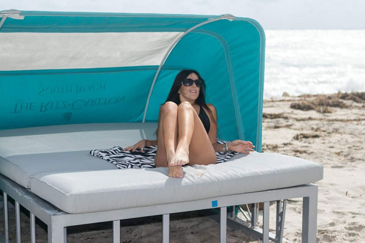 Model Claudia Romani wears Black Swimsuit at South Beach in Miami