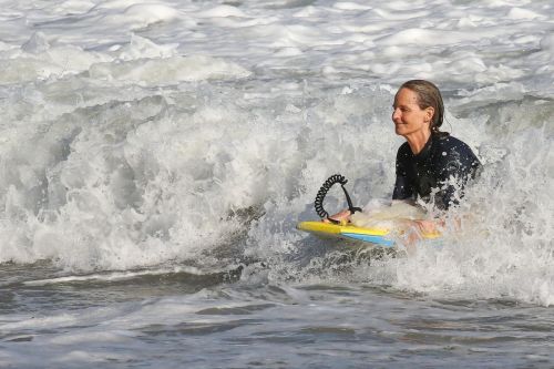 Helen Hunt in Wetsuit Bodyboarding at a Beach in Malibu 2020/06/13