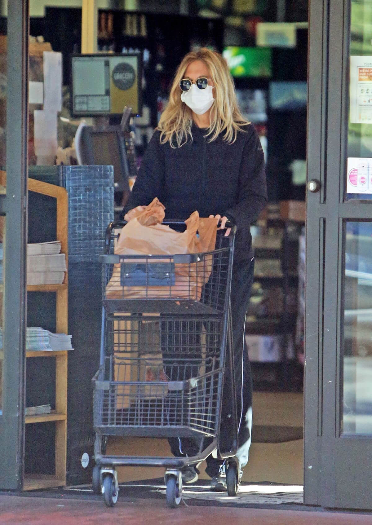 Meg Ryan in Puffer Jacket and Track Paints Out Shopping in Santa Monica 11/24/2020
