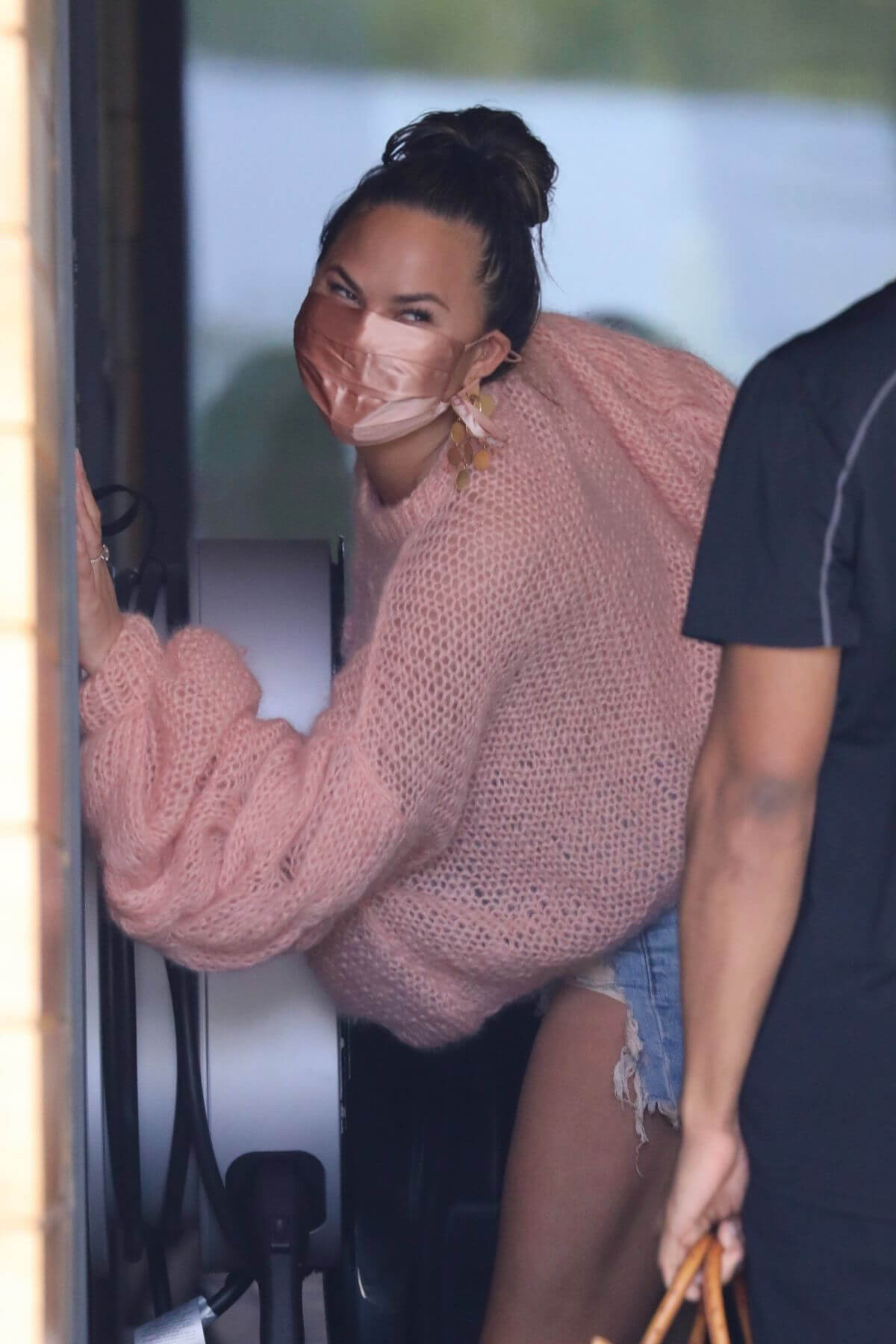 Chrissy Teigen in a Pink Top and Denim Shorts Out in Los Angeles 02/11//2021