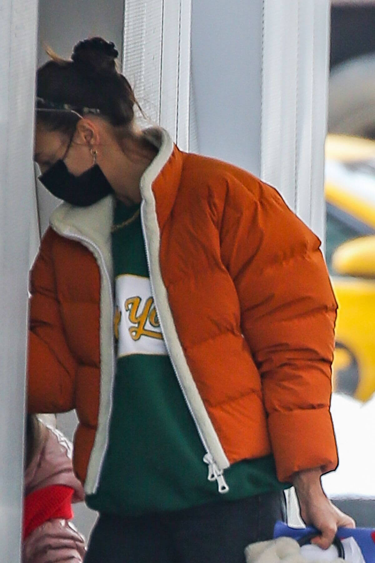 Irina Shayk in Orange Puffer Jacket Out Shopping in New York 02/11/2021
