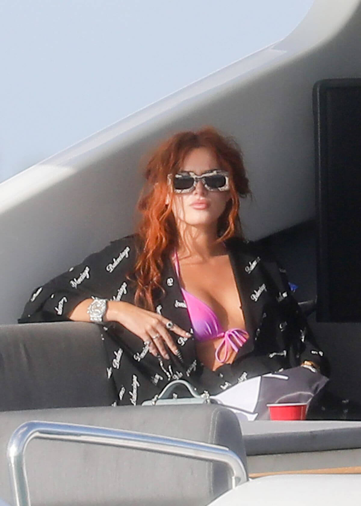 Bella Thorne Flashes Her Cleavage in Violet Bikini as She Enjoys at a Boat in Miami Beach 03/11/2021