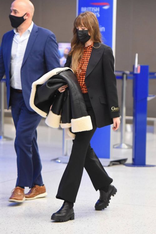 Dakota Johnson in Checked Shirt With Gucci Suits at JFK Airport in New York 1