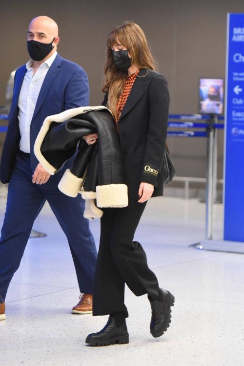 Dakota Johnson in Checked Shirt With Gucci Suits at JFK Airport in New York 2