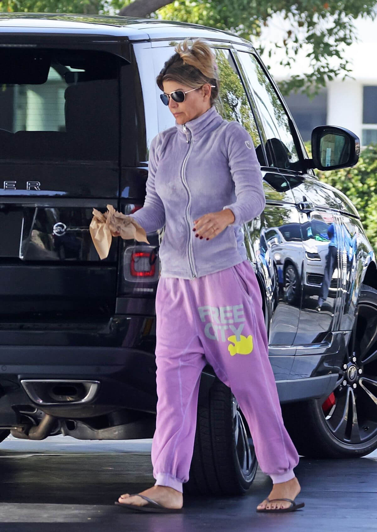 Lori Loughlin seen in FREE CITY Track Paints at a Gas Station in Los Angeles 11/19/2021