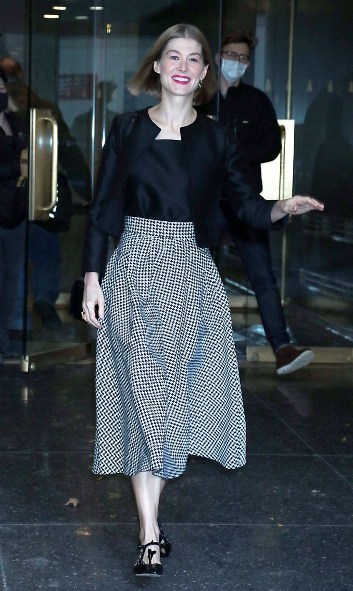 Rosamund Pike seen in Retro Check Long Skirt Out in New York 11/19/2021