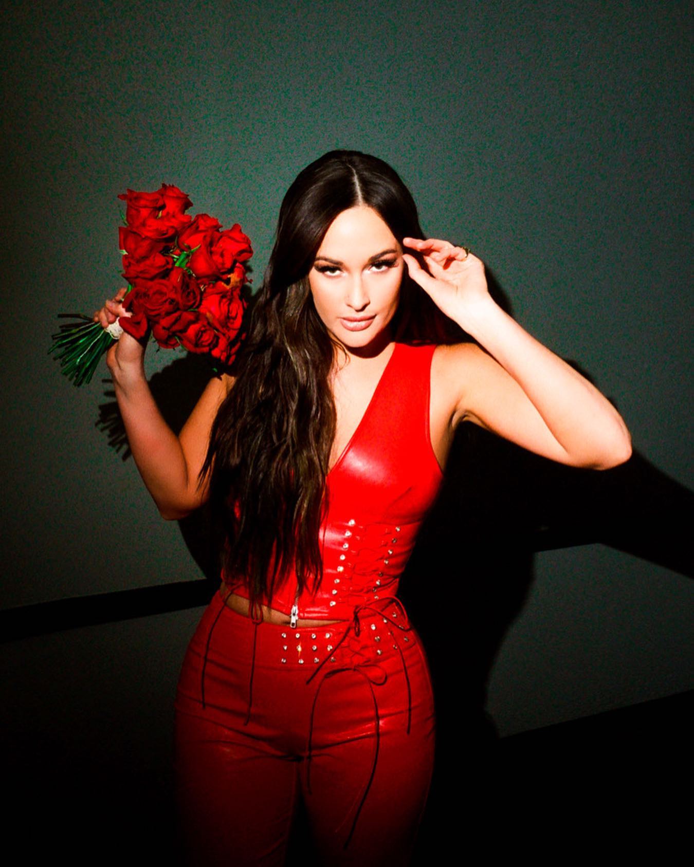 Kacey Musgraves Photoshoot in Red Attire with Holding Red Rose Bouquet, February 2022