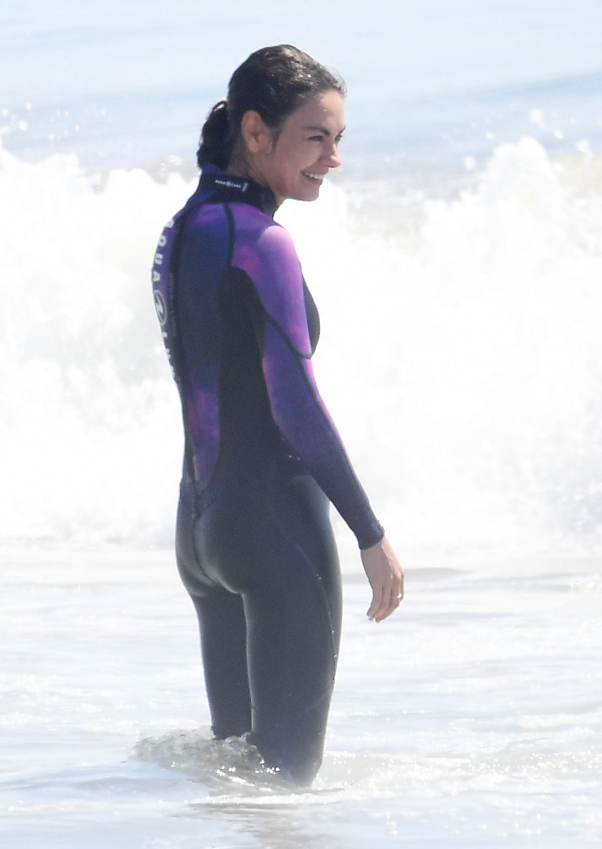 Mila Kunis in Purple Wetsuit at a Beach in Santa Barbara