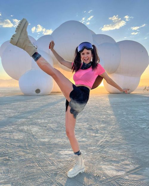 Nina Dobrev seen in Pink Top with Black Short Skirt at Burning Man Event 1