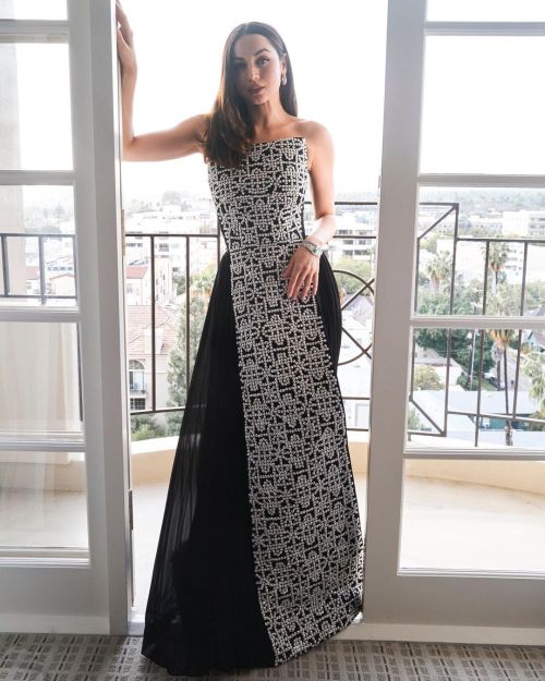 Beauty photoshoot of Ana De Armas in balcony wearing long Louis Vuitton black and white dress and silver bracelet for Golden Globes 2023