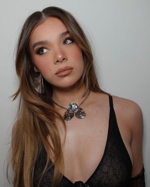 Pitch perfect singer Hailee Steinfeld fashion photoshoot wearing crossbody minidress, silver necklace and wavy hair