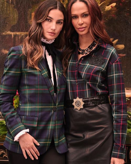 Lily Aldridge side by side celebrity photoshoot with supermodel Joan Smalls in checks blazer, high collar shirt and black pants