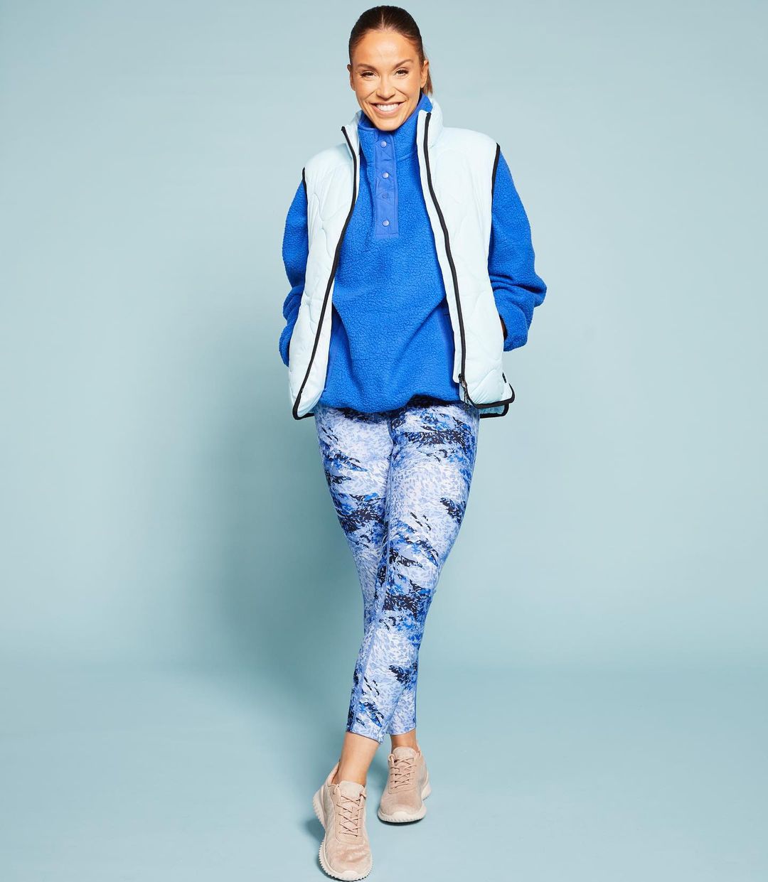 Vicky Pattison Fashion photoshoot in a sky-blue half jacket, ocean blue hoodie, blue and white sweats and skin color sports shoes