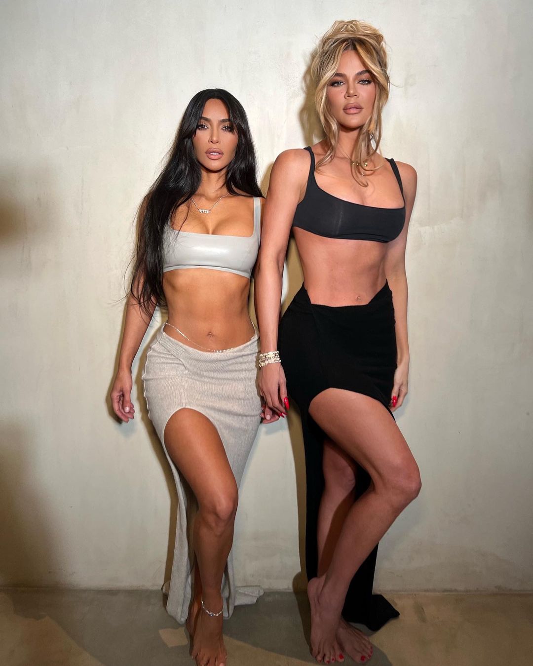 Khloe and Kim Kardashian poses in Black and Silver Split Dress During Photoshoot, Feb 2023