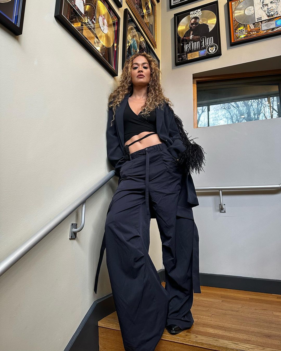 Rita Ora wears in a plunging black crop top photos in the studio, Feb 2023