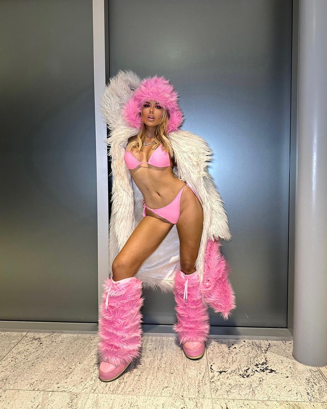 Tallia Storm poses in Tiny Pink Bikini and Fur Coat at Brit Awards 2023 in O2 Arena in London