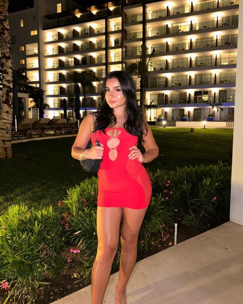 Tati McQuay mesmerizes with her confident fashion choices and toned legs in a red short dress