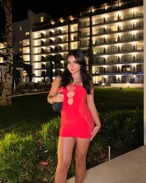 Tati McQuay mesmerizes with her confident fashion choices and toned legs in a red short dress
