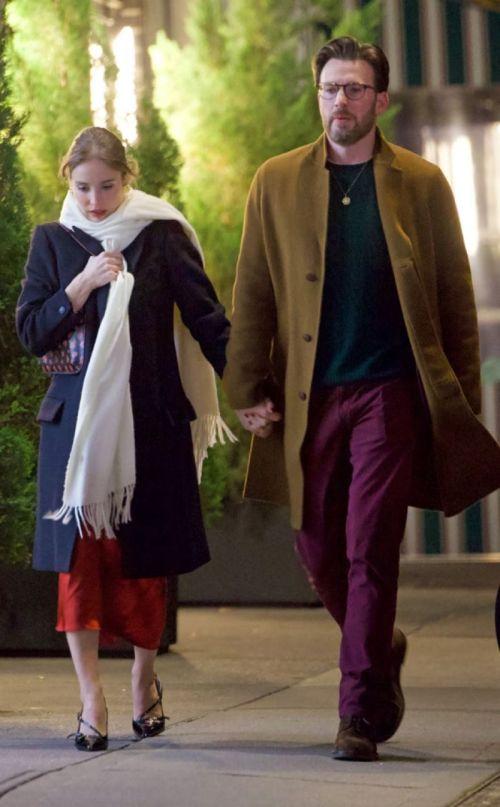 Alba Baptista in navy coat and red skirt