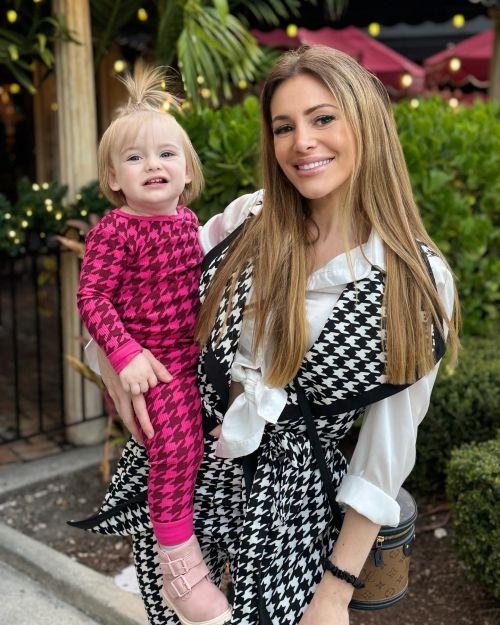Caroline Hoban poses with baby photos 1