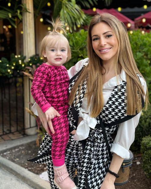 Caroline Hoban poses with baby photos 2