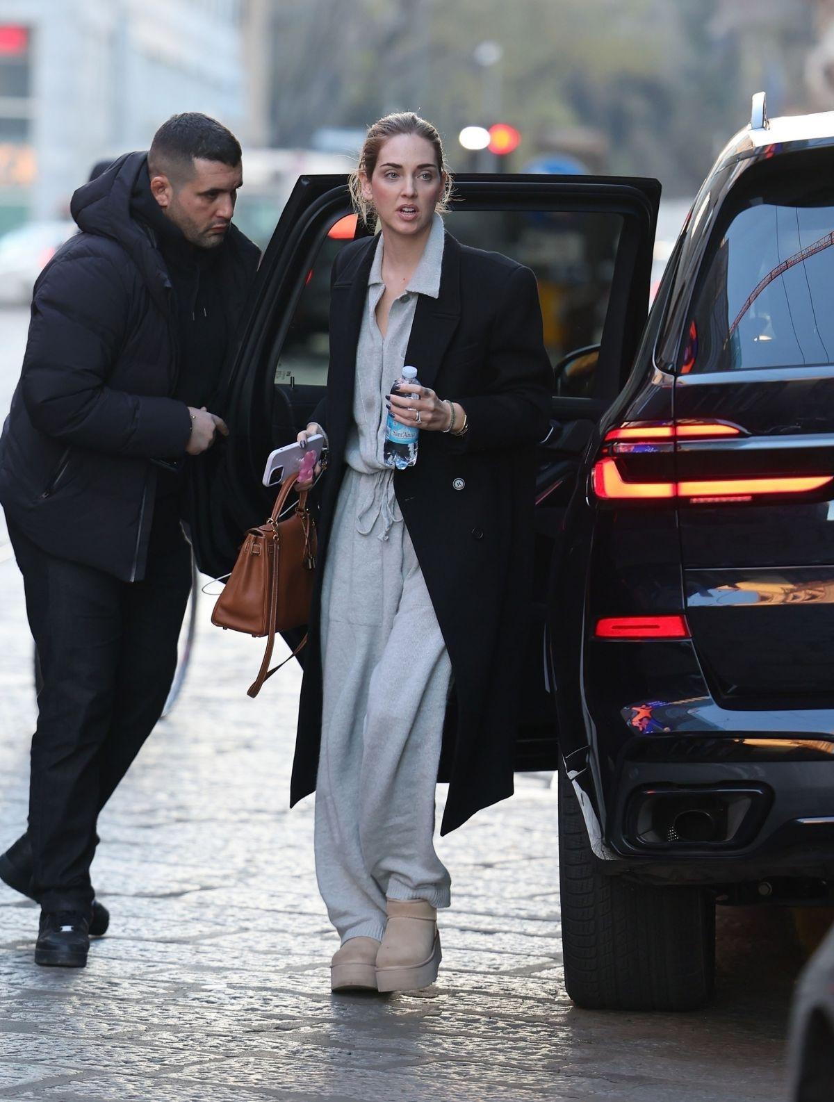 Chiara Ferragni wearing a long overcoat and grey dress in Milan.