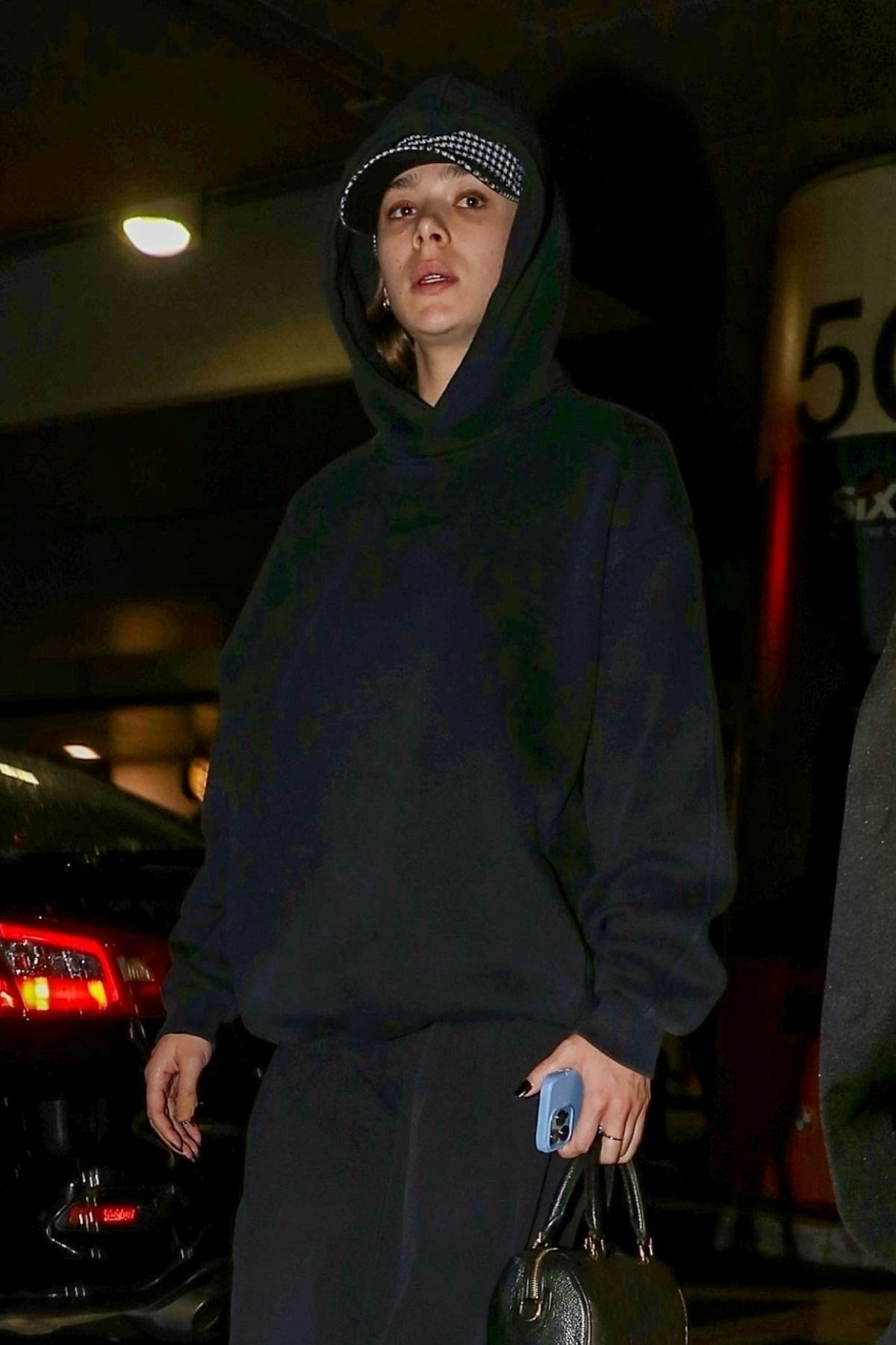 Hailee Steinfeld Casual Chic in Black Hoodie at LAX