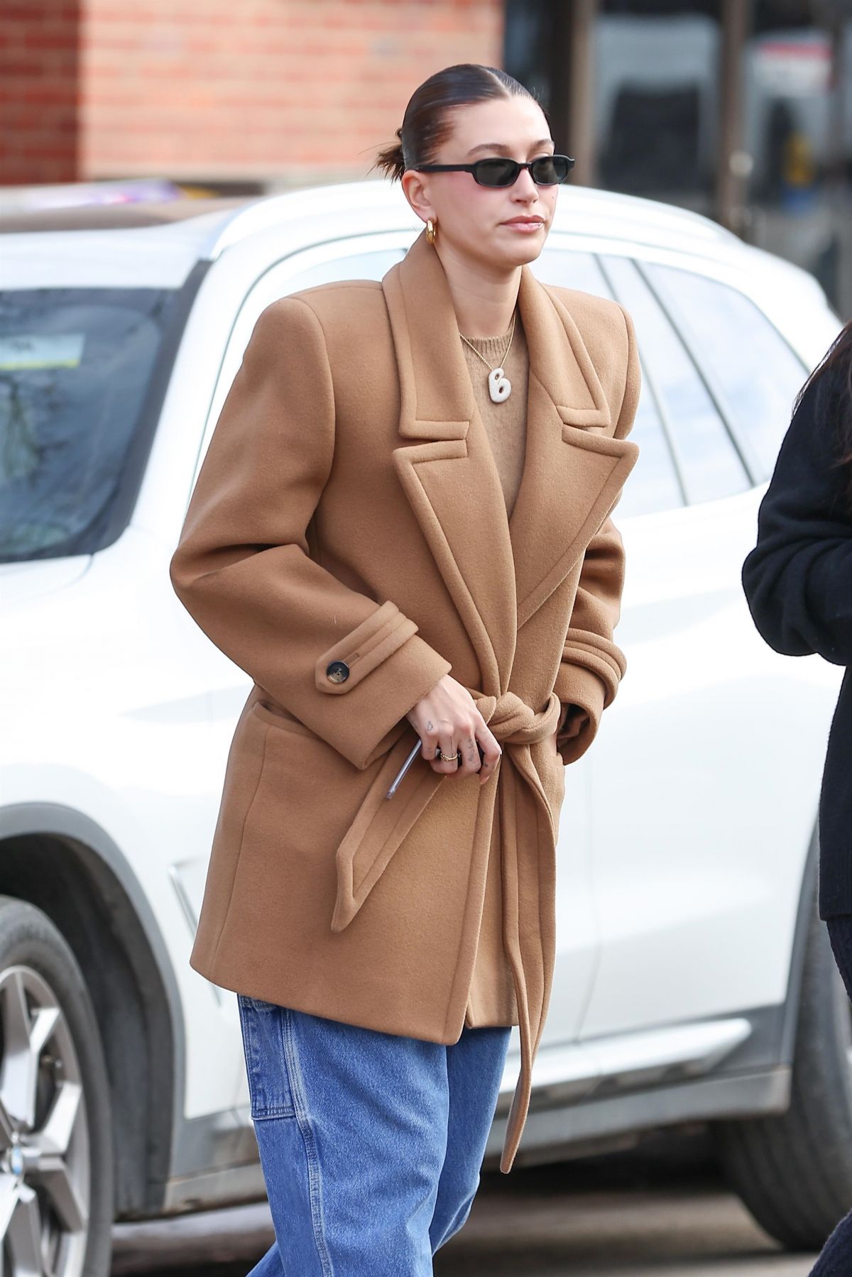 Hailey Bieber in Aspen Breakfast Look: Long Brown Jacket & Denim Style