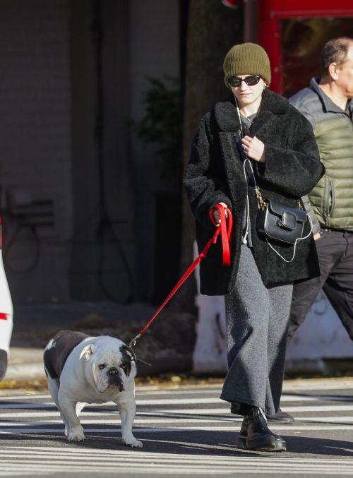 Julia Garner walking her bulldog